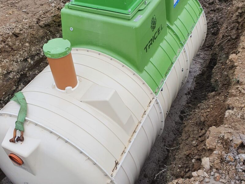 Sewage treatment plant set into an excavated trench