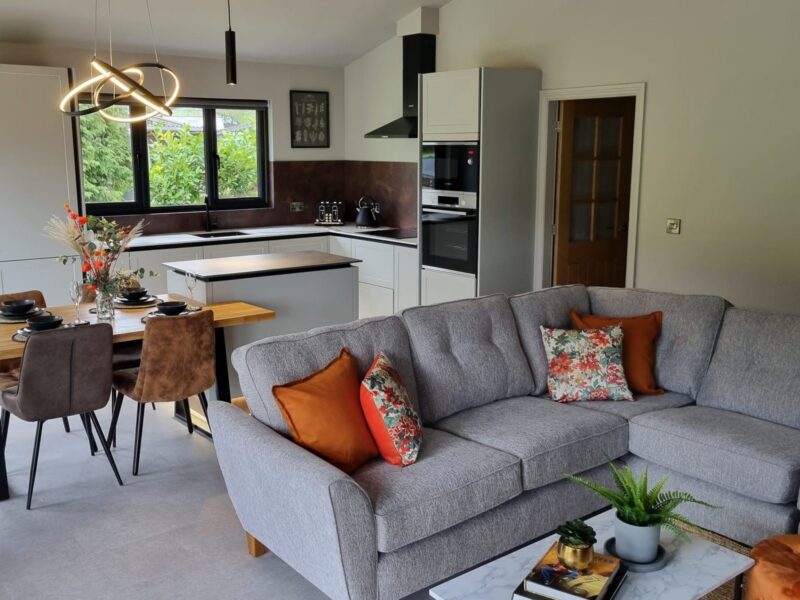 Living area looking through to the kitchen, with a dining table in the foreground