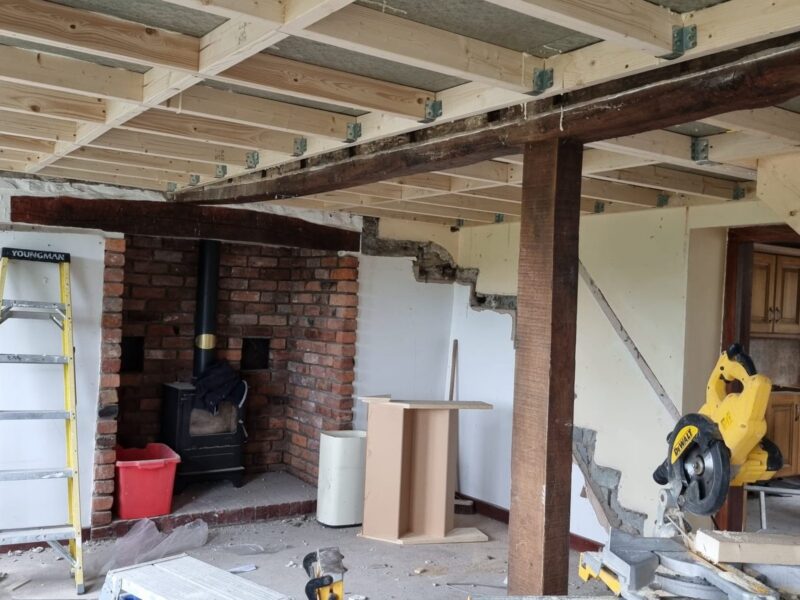 First-fix carpentry underway, with new joists installed and a saw bench set up