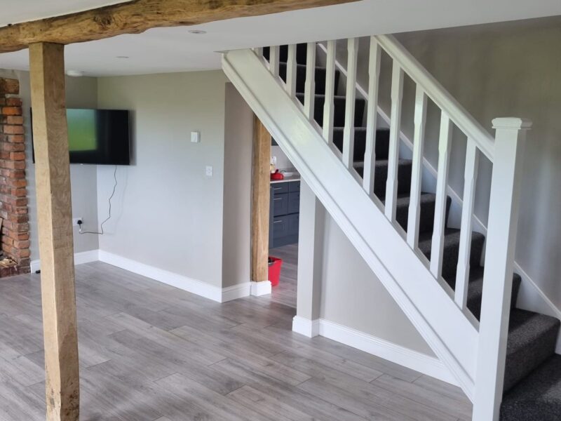 Lounge with exposed oak posts, new flooring and the new staircase