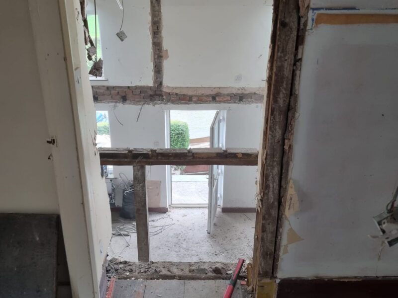 Interior stripped back to bare timber framing, with the floor lifted